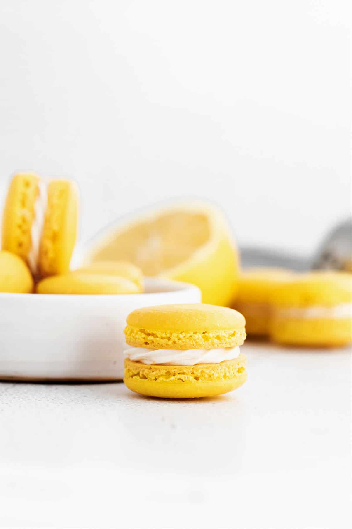 Lemon maracrons on a white plate.