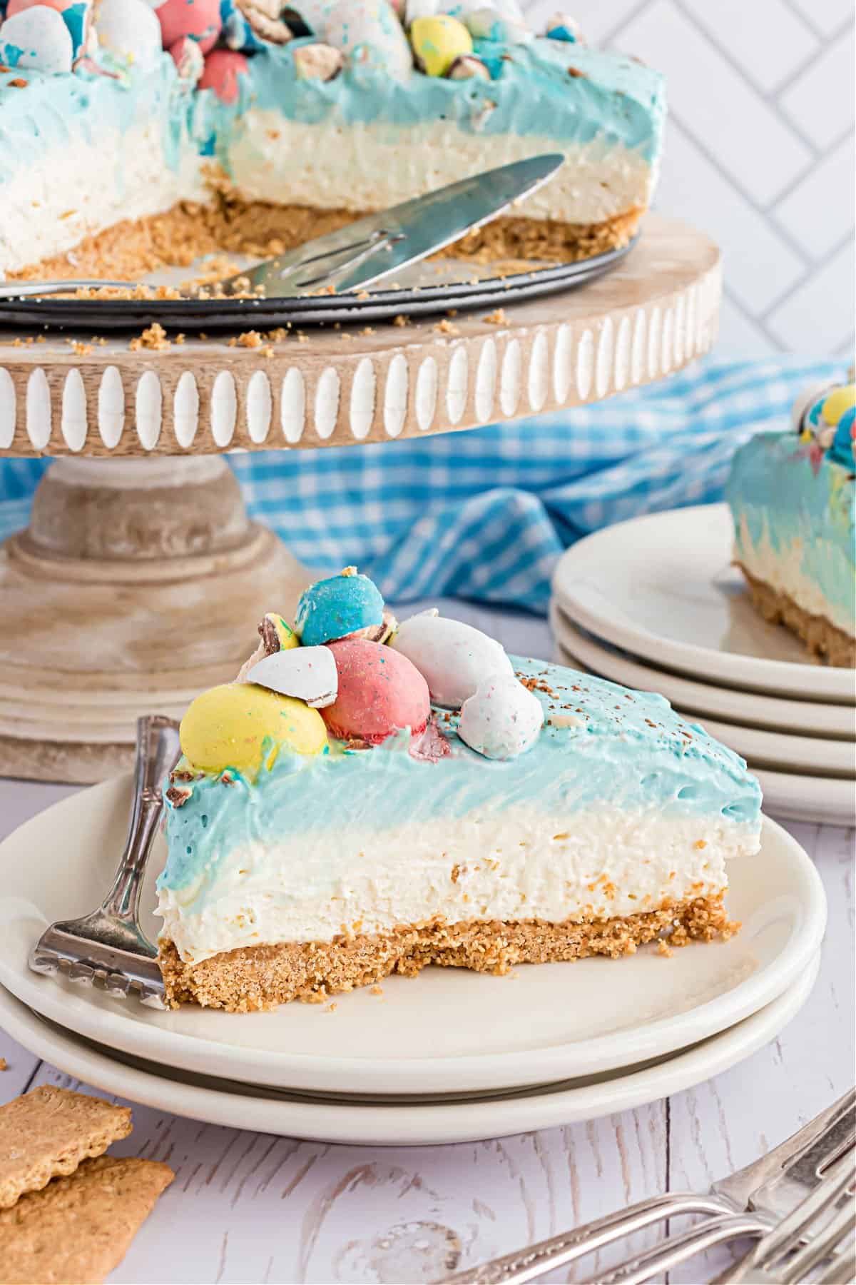 Layered cheesecake with graham cracker, filling, and blue topping.