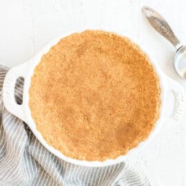 Graham cracker crust in a pie plate.