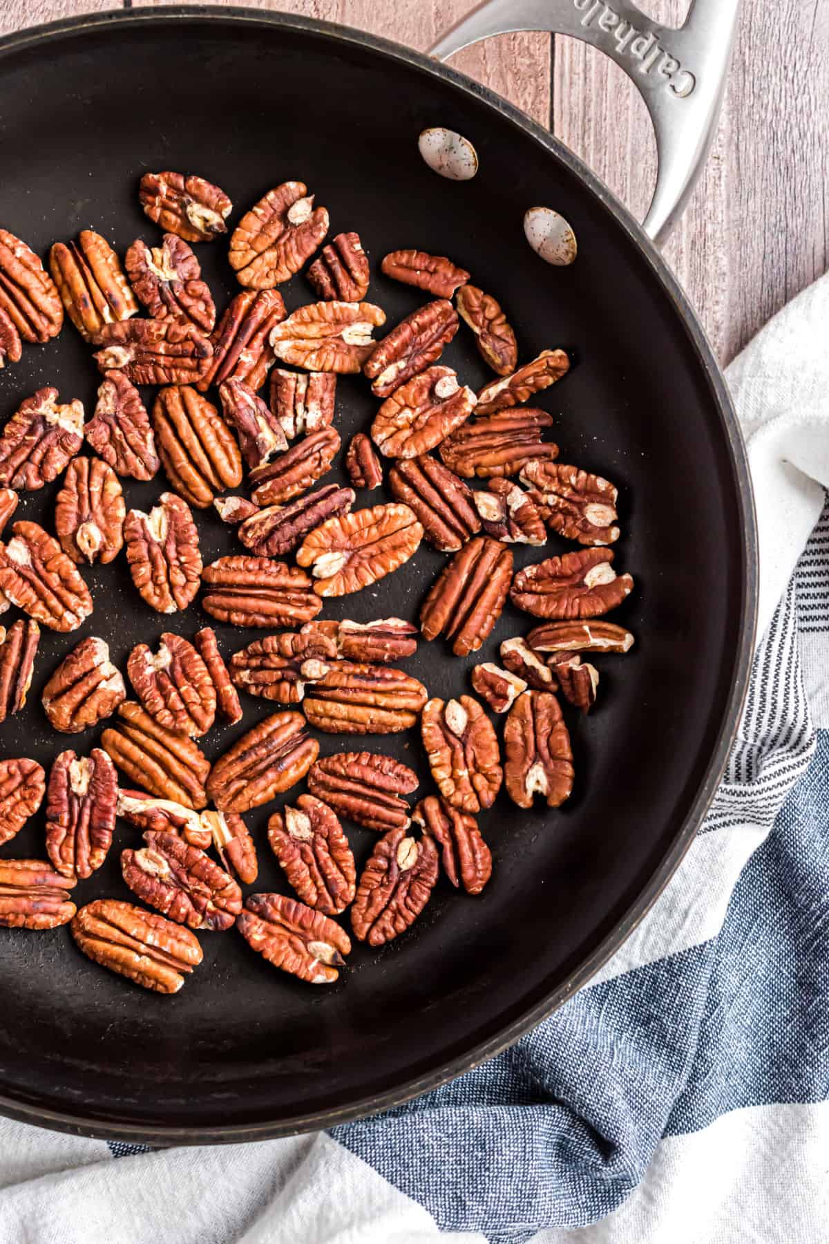 Pecans in a black skillet for toasting.