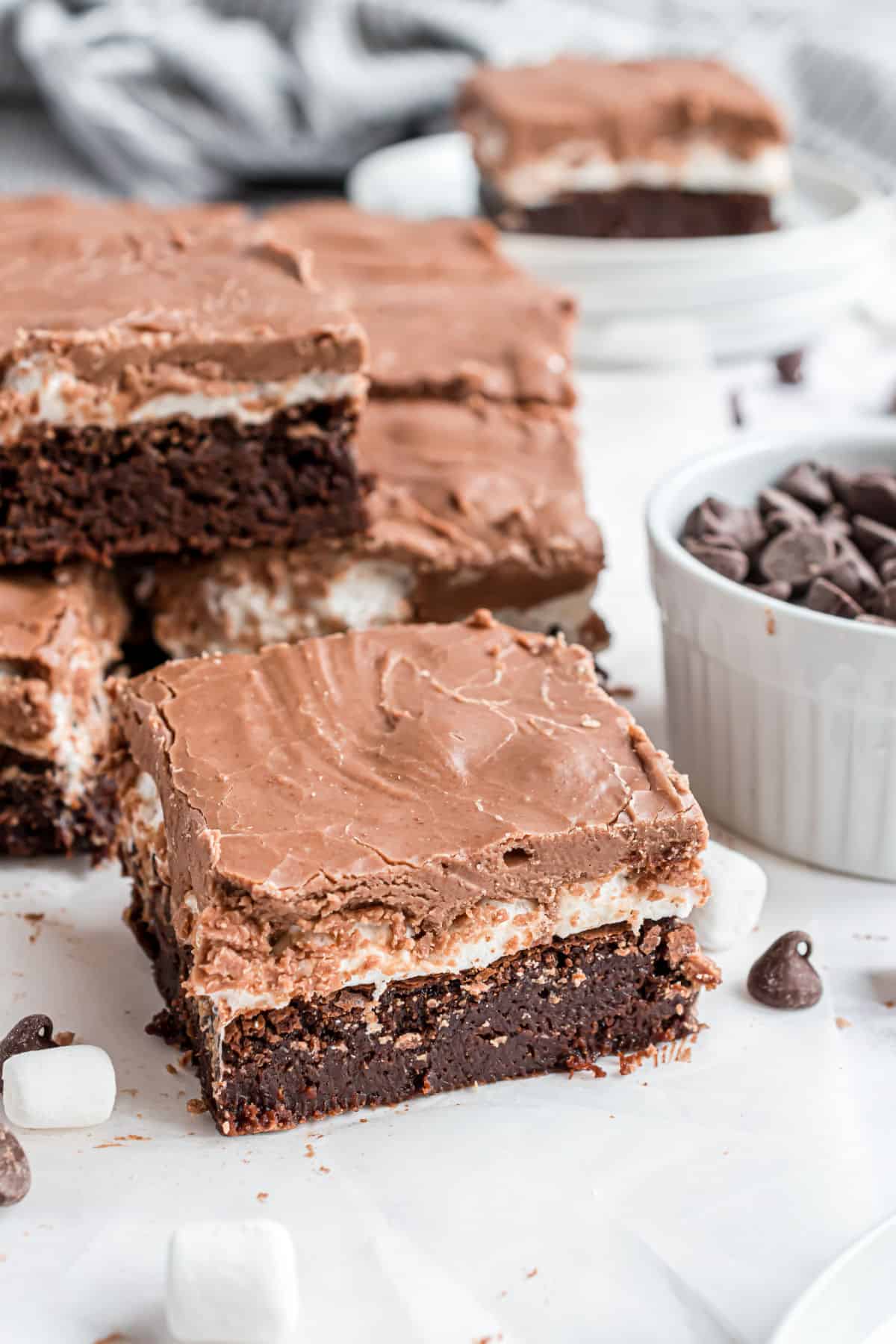 Slice of brownie with marshmallow and chocolate icing.