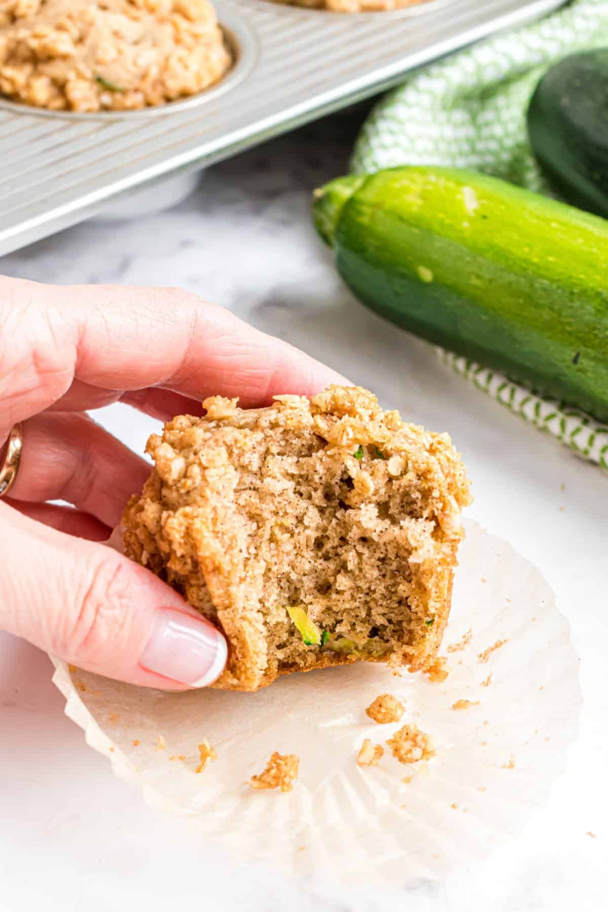 Zucchini muffin with a bite taken out.