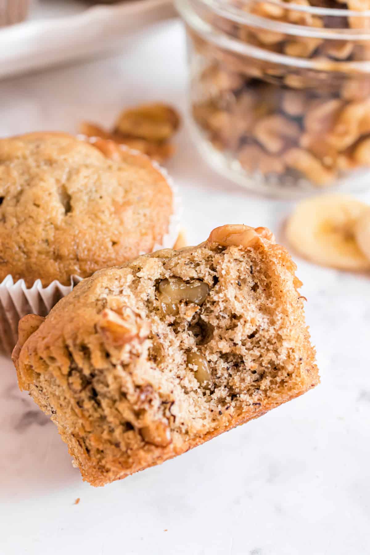 Banana nut muffins with a bite taken.