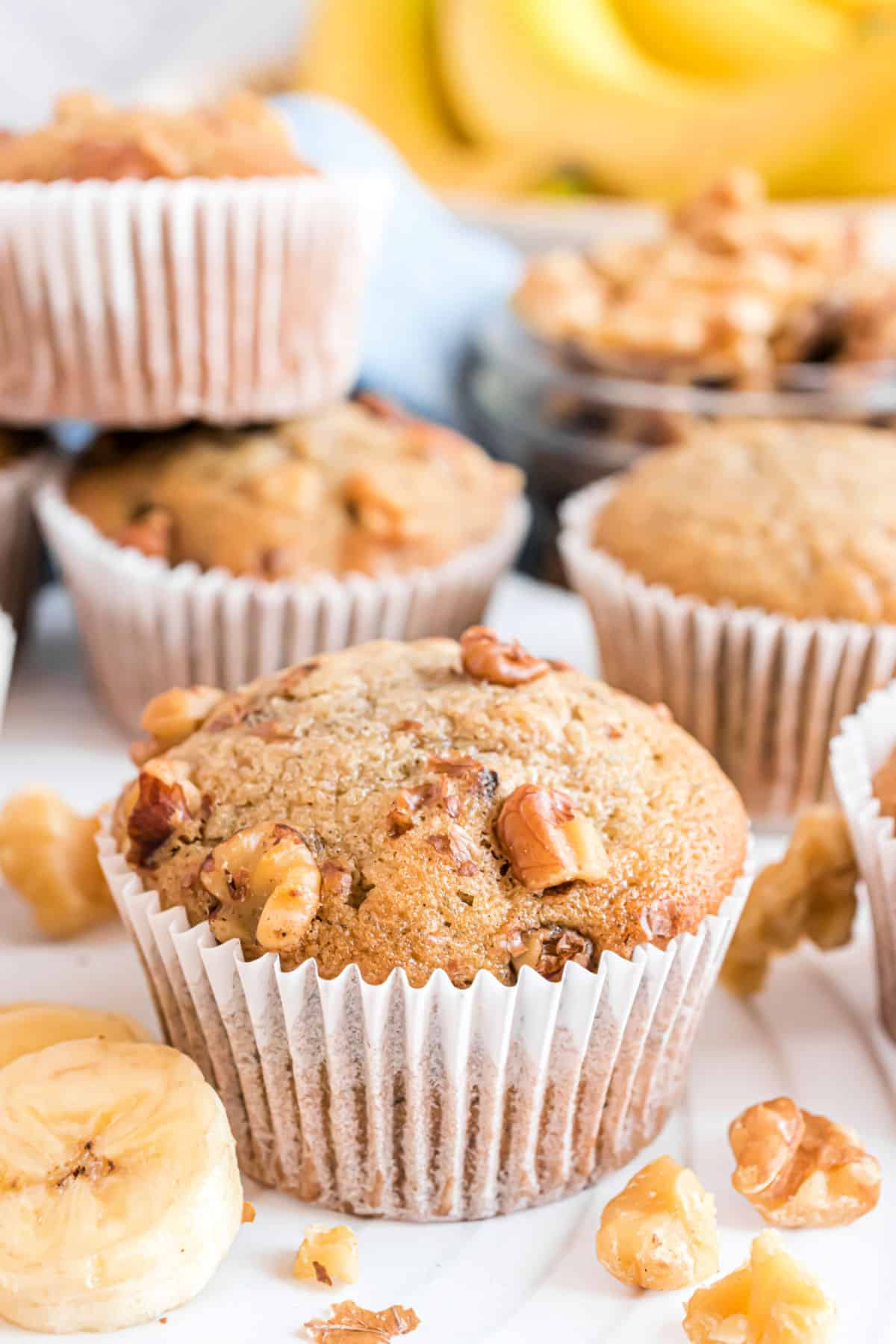 Banana nut muffin in white paper wrapper.