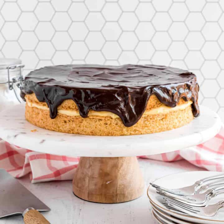 This classic Boston Cream Pie recipe brings together light sponge cake and a divine custard filling. With a sweet chocolate glaze and homemade pastry cream, Boston Cream Pie has everyone coming back for more!