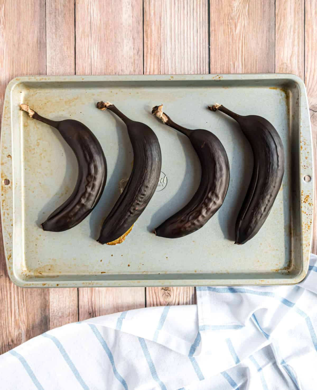 Brown ripe bananas on a baking sheet.