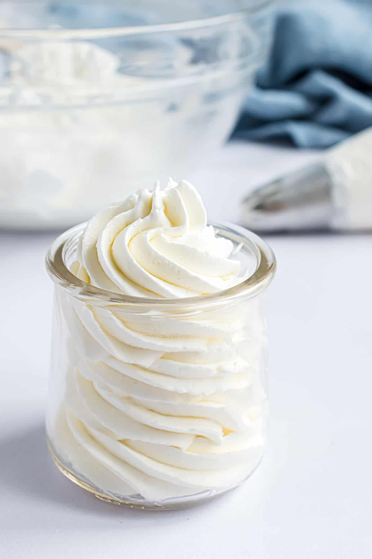 Stabilized whipped cream piped into a small jar.