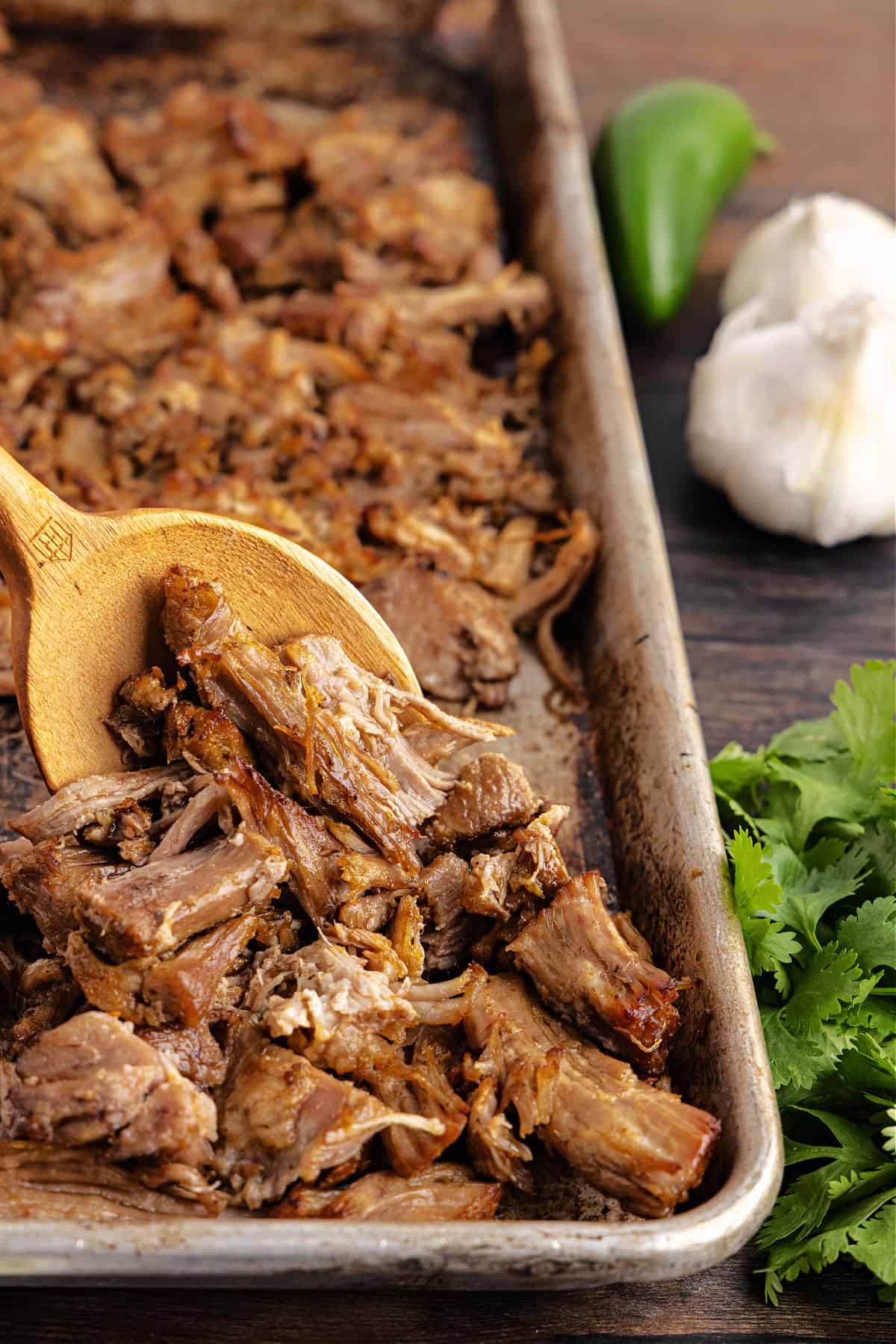 Carnitas baked crispy on a baking sheet.