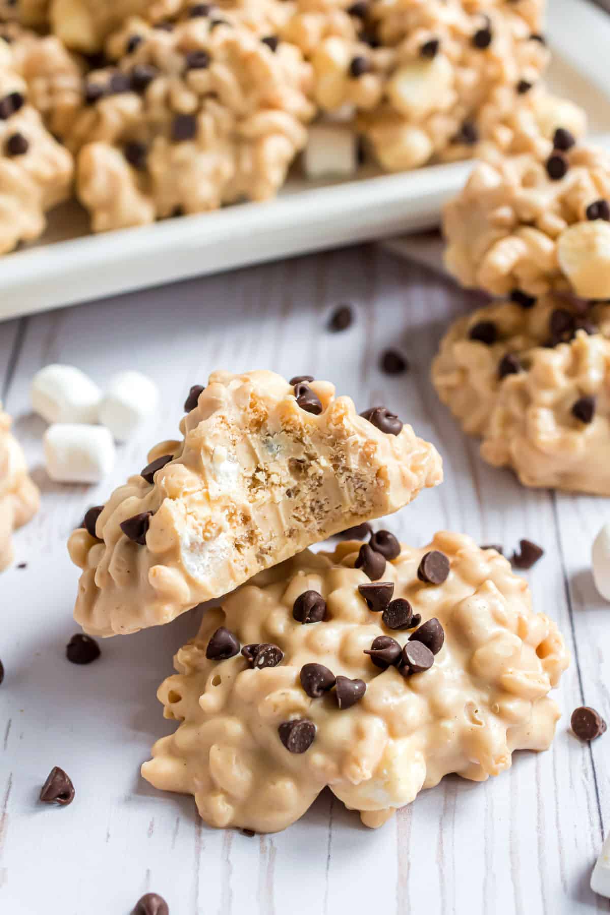 Stack of avalanche cookies with one bite removed.