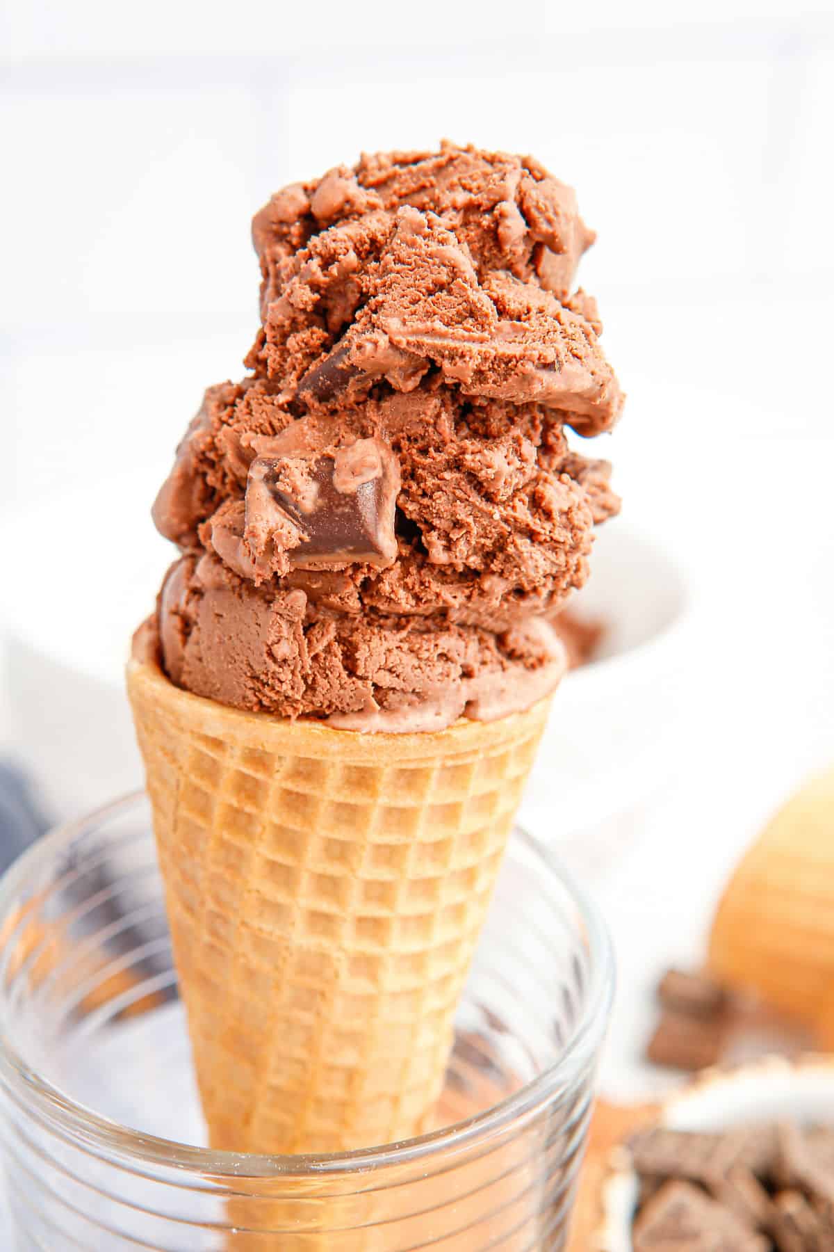 Chocolate chunk ice cream on a sugar cone.