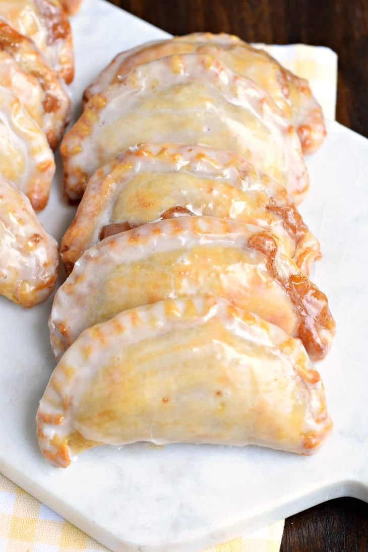 Peach hand pies on a white serving plate.