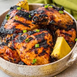 Learn how to make perfect Huli Huli Chicken on the grill. Marinated in a tangy sweet sauce with garlic and ginger, this easy chicken recipe is a perfect main dish for your next grill night!