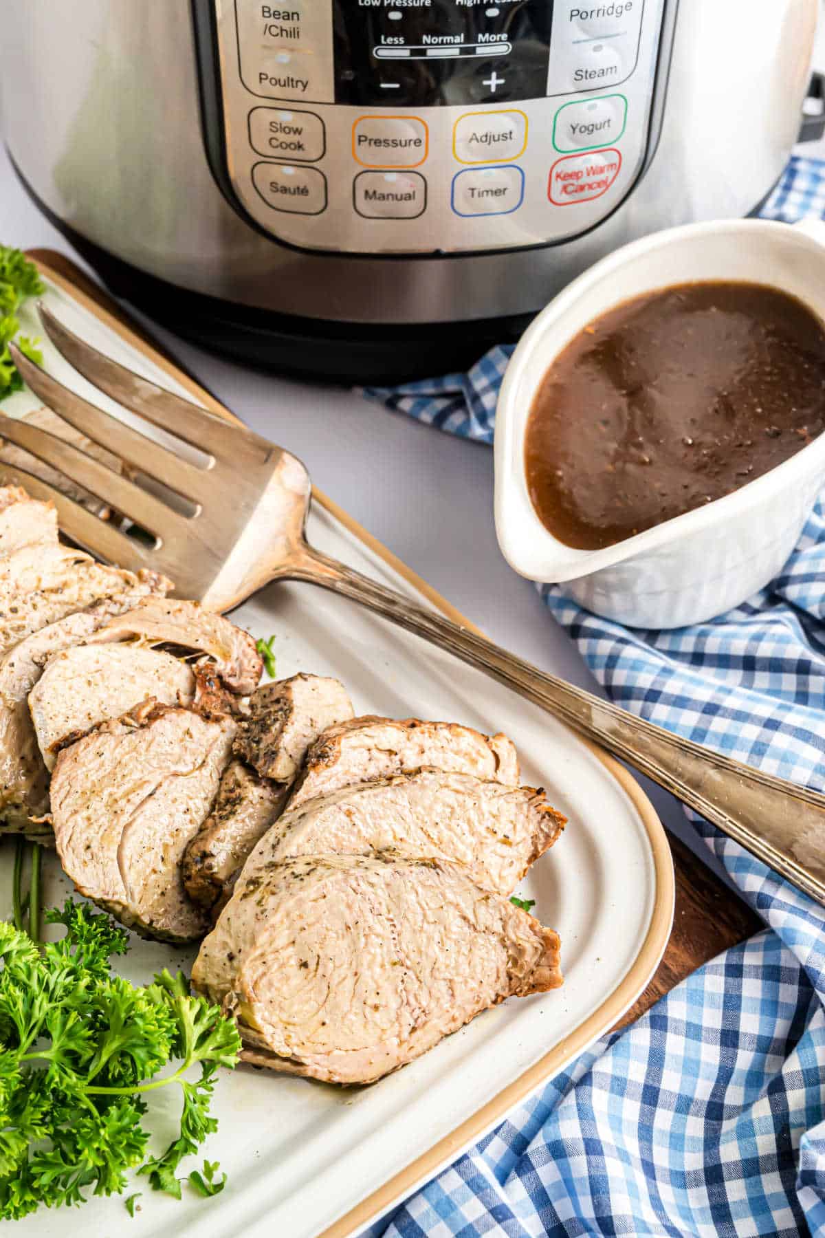 Pork tenderloin slices on a white platter.