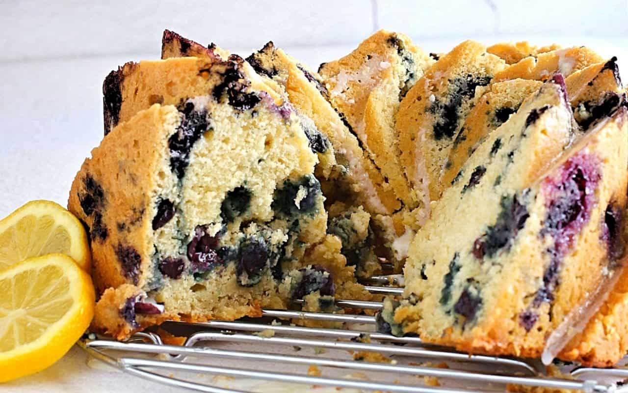 Lemon blueberry cake on a wire rack.