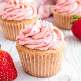 These Strawberry Cupcakes are perfectly sweet, pink and bursting with strawberry flavor. Fluffy strawberry flavored cupcakes are topped with strawberry buttercream for a delicious single-serving dessert!