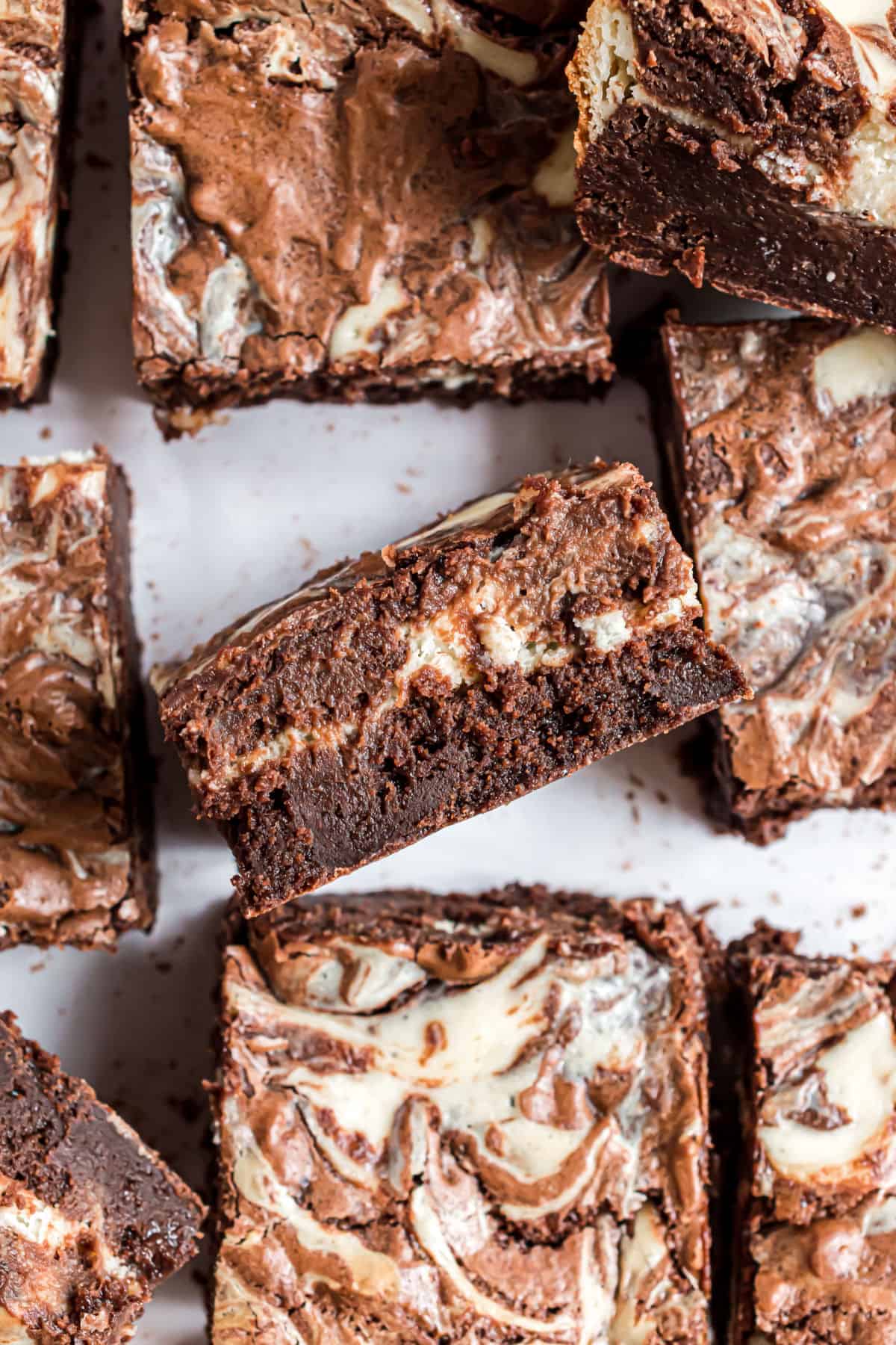Brownies swirled with cheesecake topping cut into squares.
