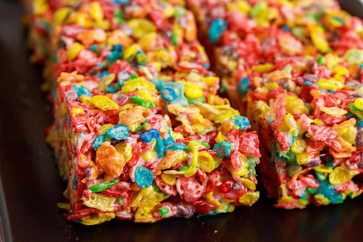 Fruity Pebbles Treats are no bake dessert bars with only 4-ingredients. Easy to make and fun to eat, these gooey treats are a hit with the whole family!