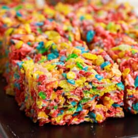 Fruity Pebbles Treats are no bake dessert bars with only 4-ingredients. Easy to make and fun to eat, these gooey treats are a hit with the whole family!