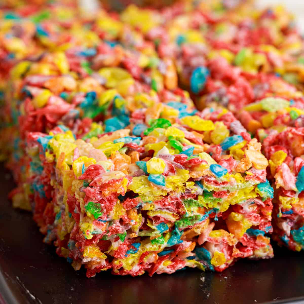 Fruity Pebbles Treats are no bake dessert bars with only 4-ingredients. Easy to make and fun to eat, these gooey treats are a hit with the whole family!