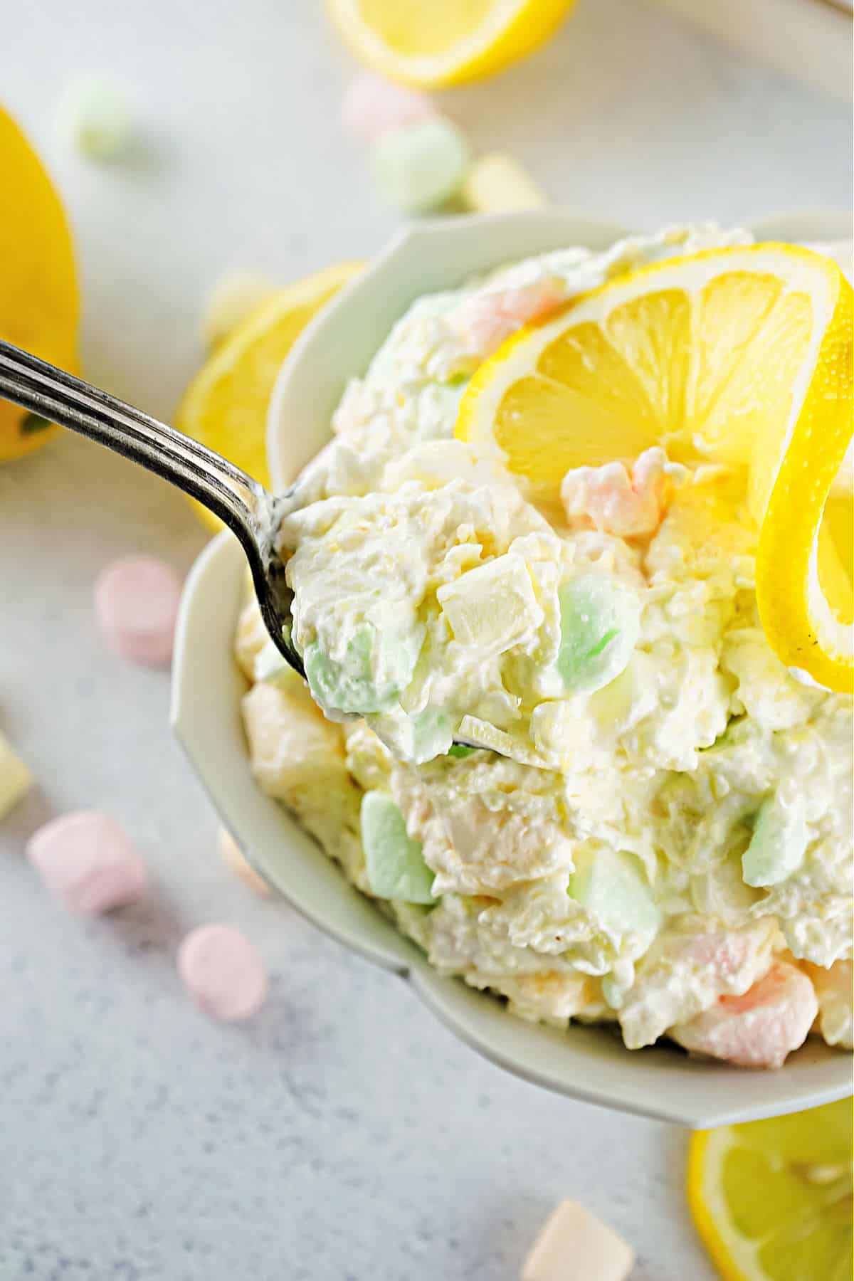 Lemon fluff salad ib a white serving bowl.