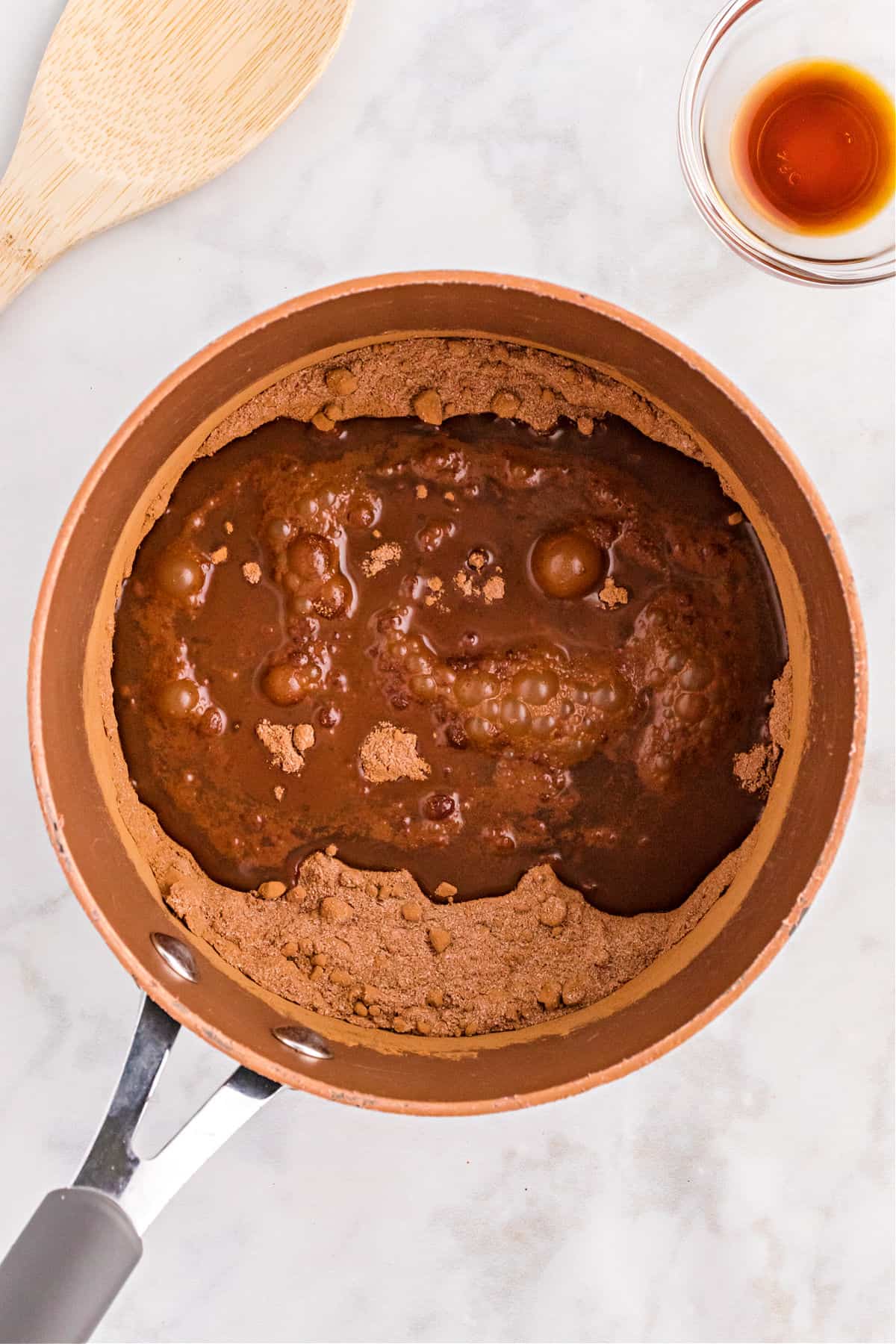 Chocolate syrup in a saucepan before thickened.