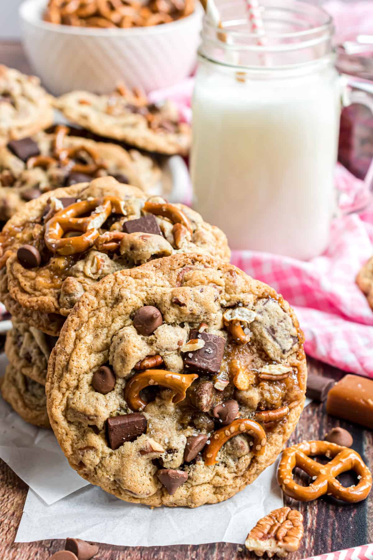 Kitchen sink cookies stacked with a glass of milk.