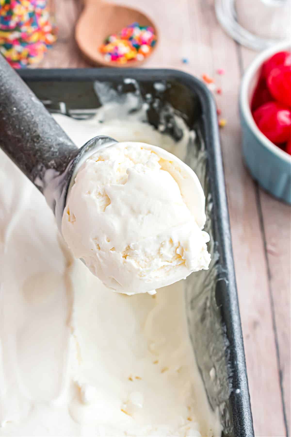 Scoop of vanilla ice cream in metal loaf pan.