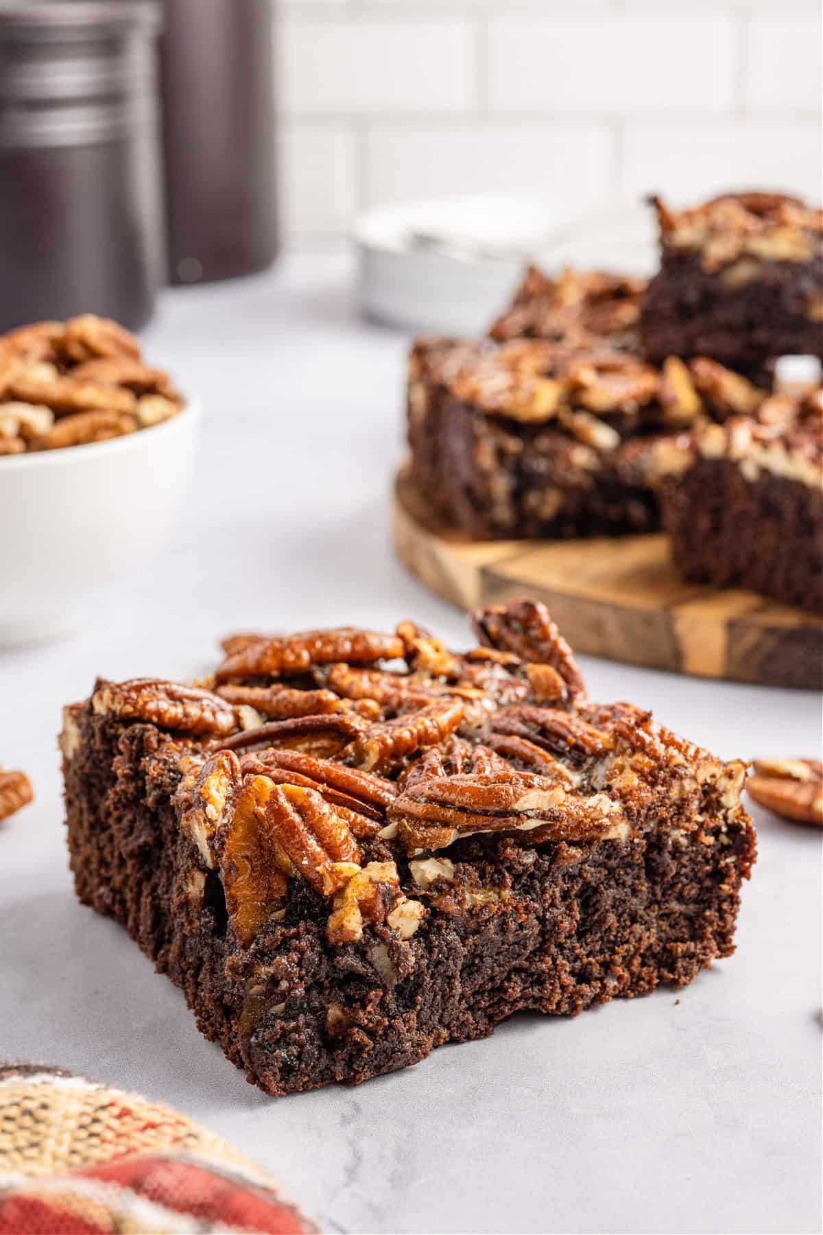 Brownie topped with pecan pie filling and cut into a large square.