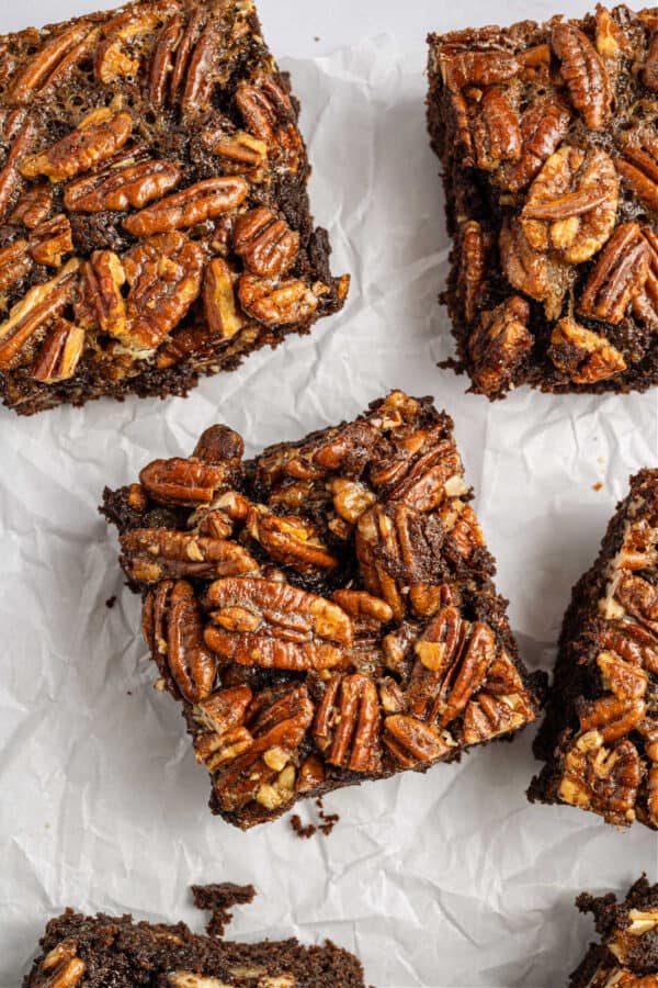 Brownies baked with a pecan pie topping and cut into squares.