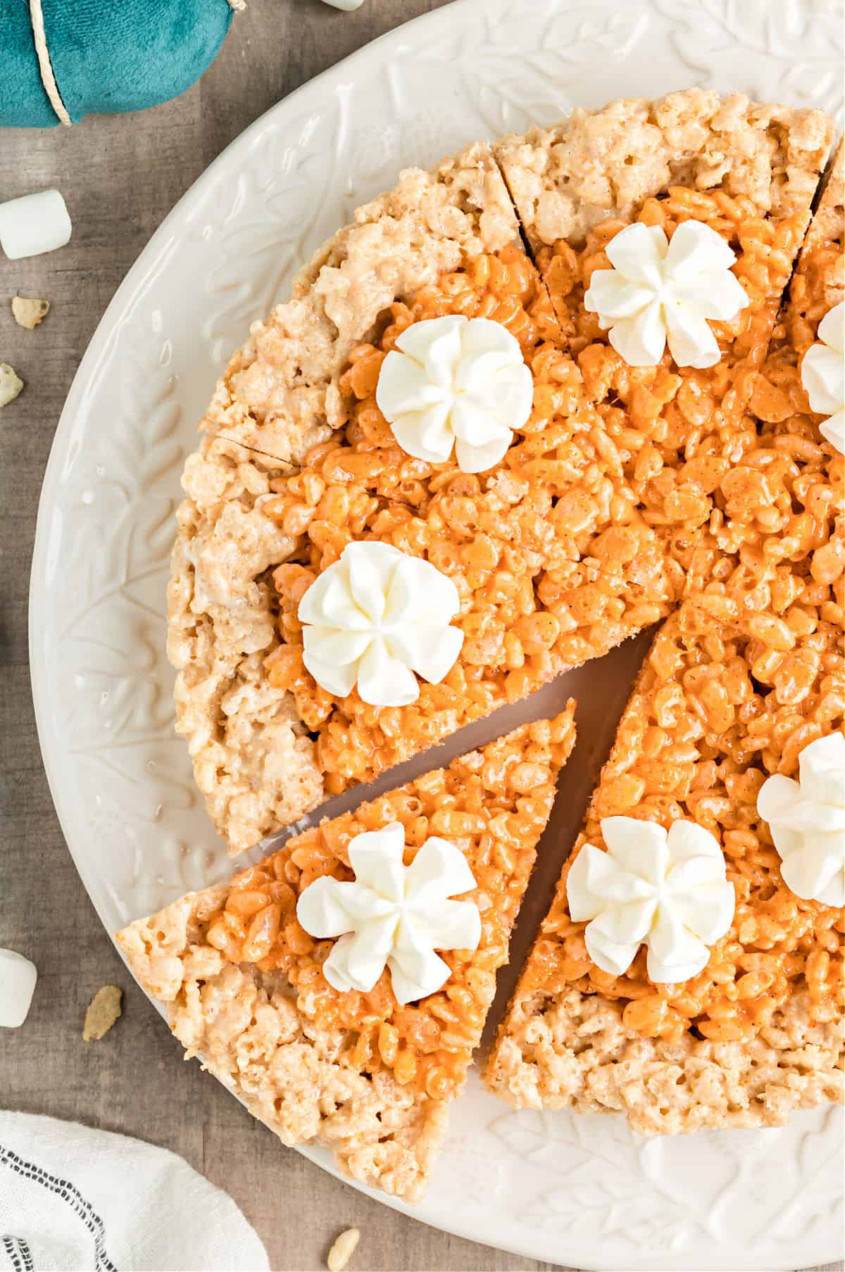 Pumpkin pie made with rice krispie treats and topped with whipped cream.