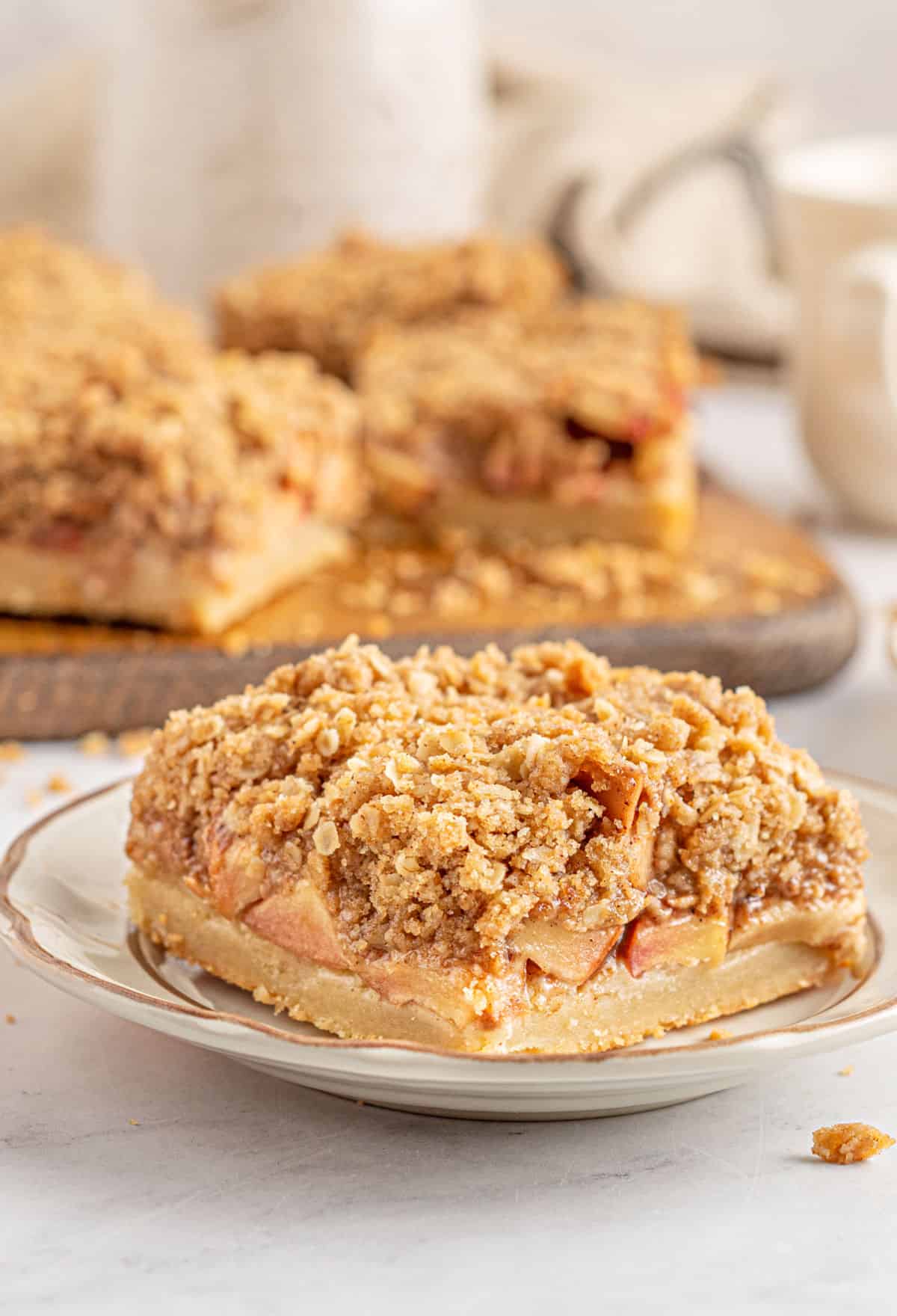 Apple pie bars on a white plate.