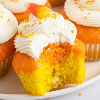 These fun Candy Corn Cupcakes have a yellow and orange layer and are topped with a delicious white marshmallowy frosting for the perfect fall and Halloween dessert!