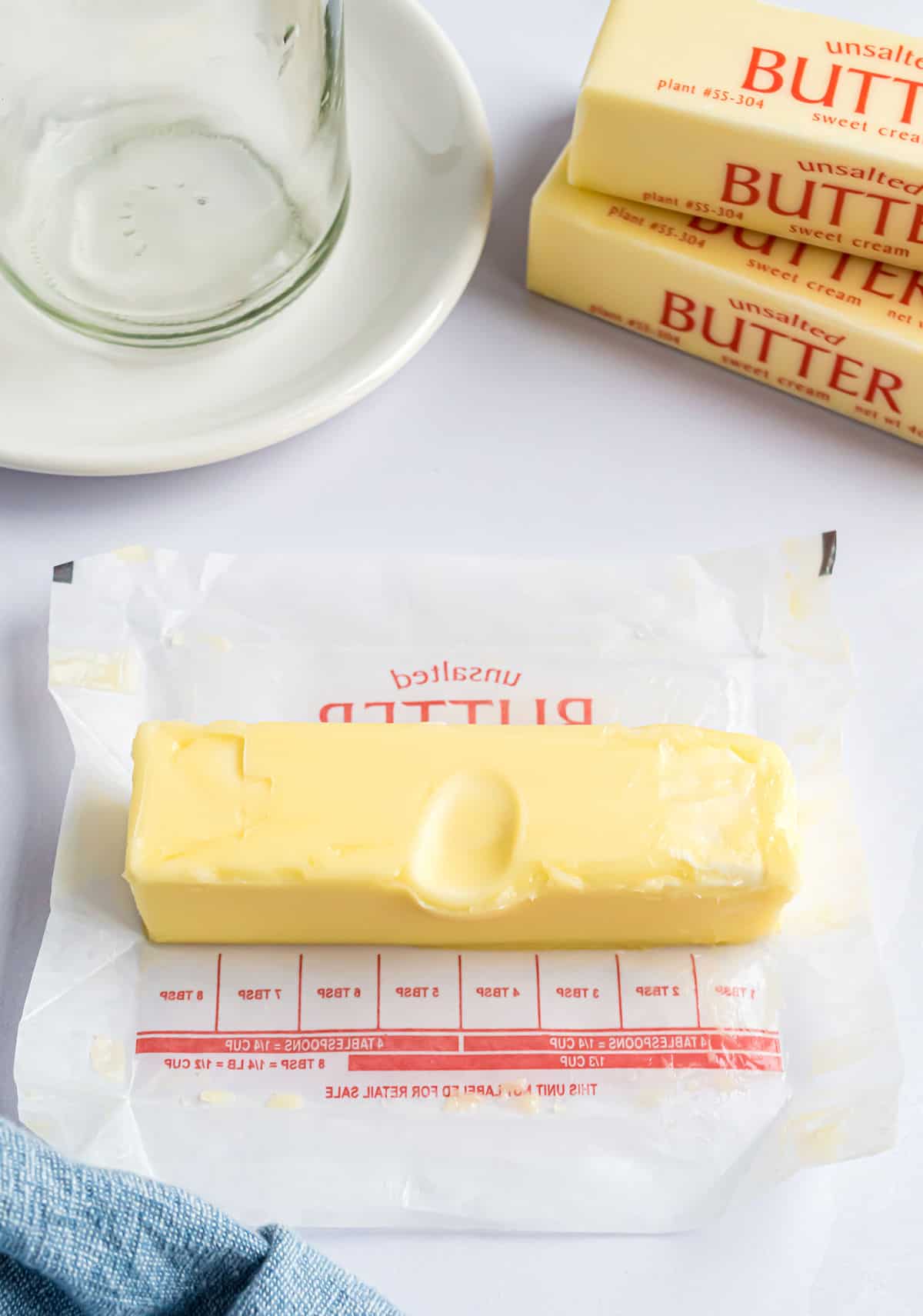 Stick of butter unwrapped with an indentation to show it's been softened.