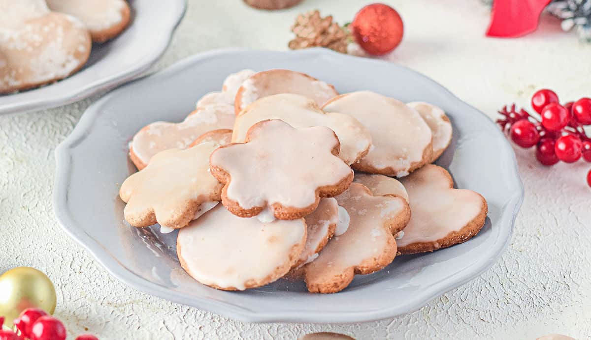 Lebkuchen cookies stacked on a light blue plate for serving.