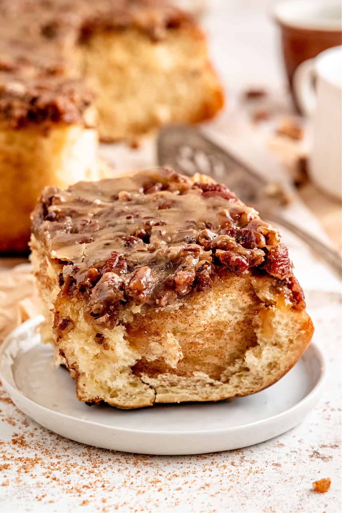 Pecan sticky bun on a serving plate.