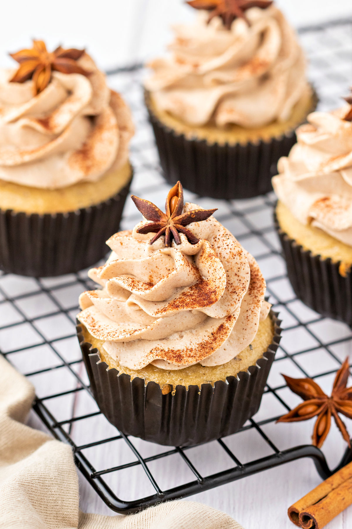 Chai cupcakes on a wire cooling rack.