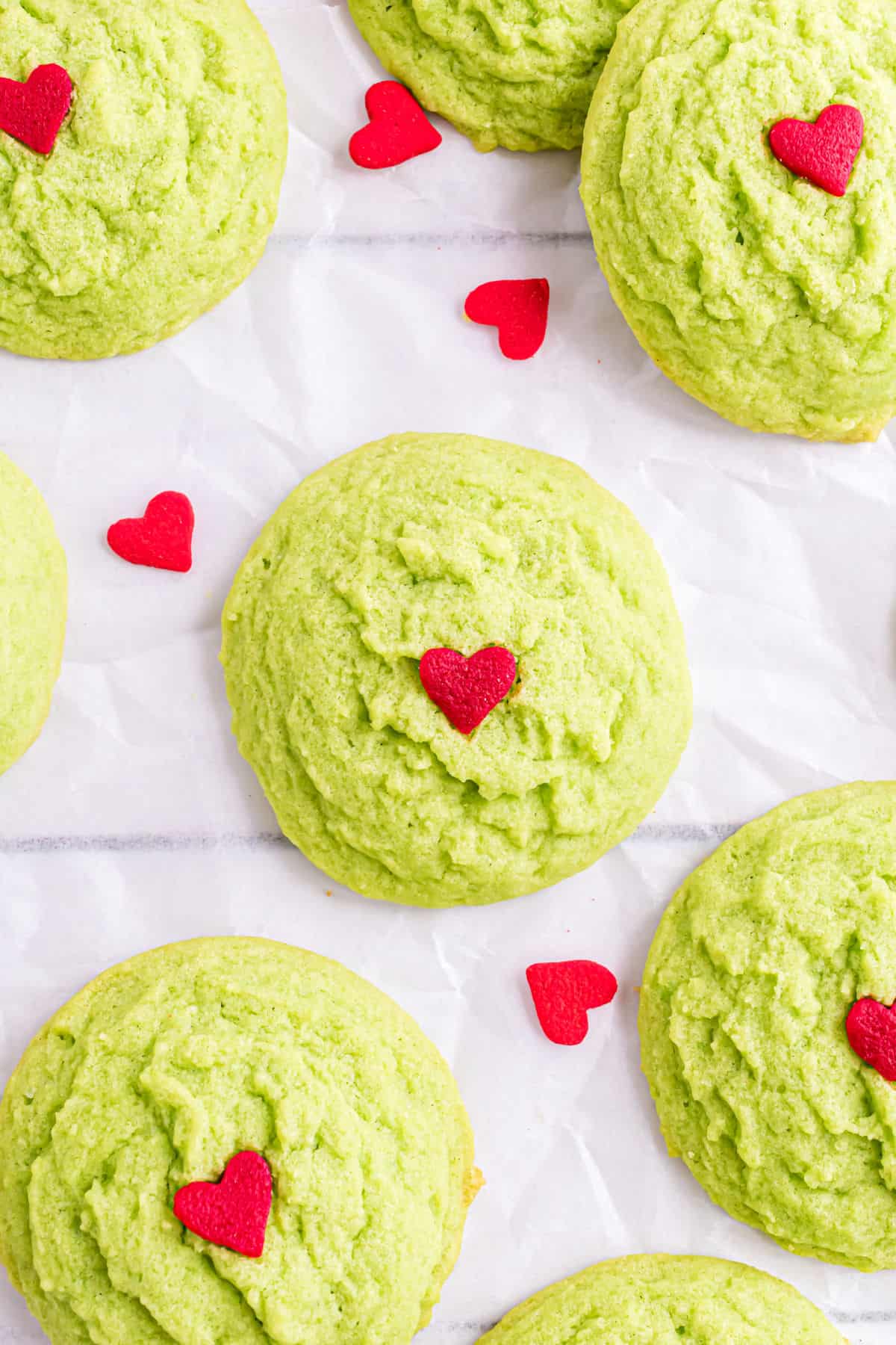 Grinch cookies on parchment paper.