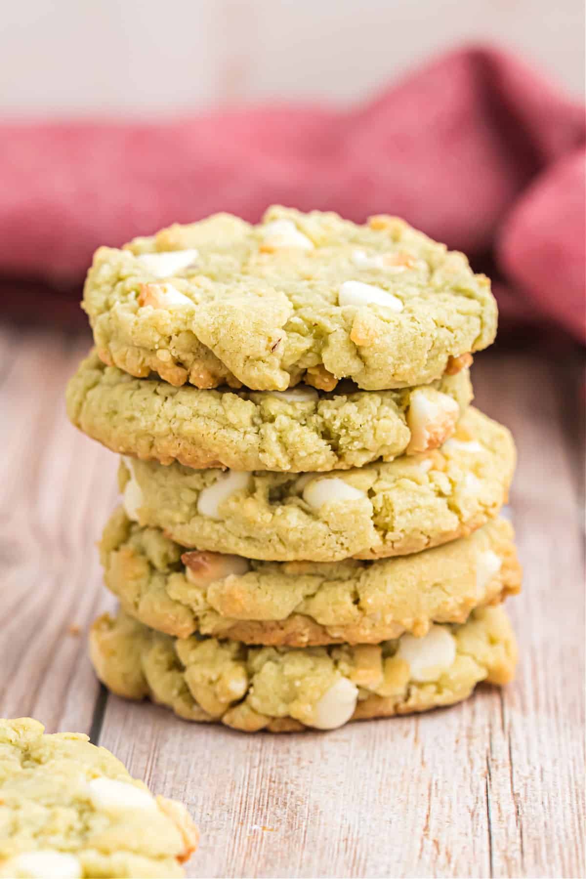 Five pistachio cookies stacked on top of each other.