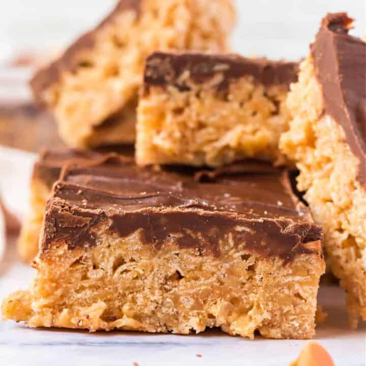 Craving Rice Krispies but also chocolate and peanut butter . . . and butterscotch? Scotheroos are chewy cereal bars with a rich peanut butter flavor and topped with melted chocolate. An easy no bake treat!