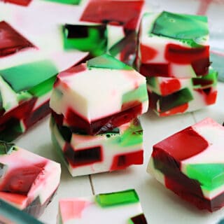 Broken Glass Jello has colorful cubes of Jell-o combined with a creamy gelatin mixture to create a beautiful design. An easy holiday dessert you can make ahead of time!
