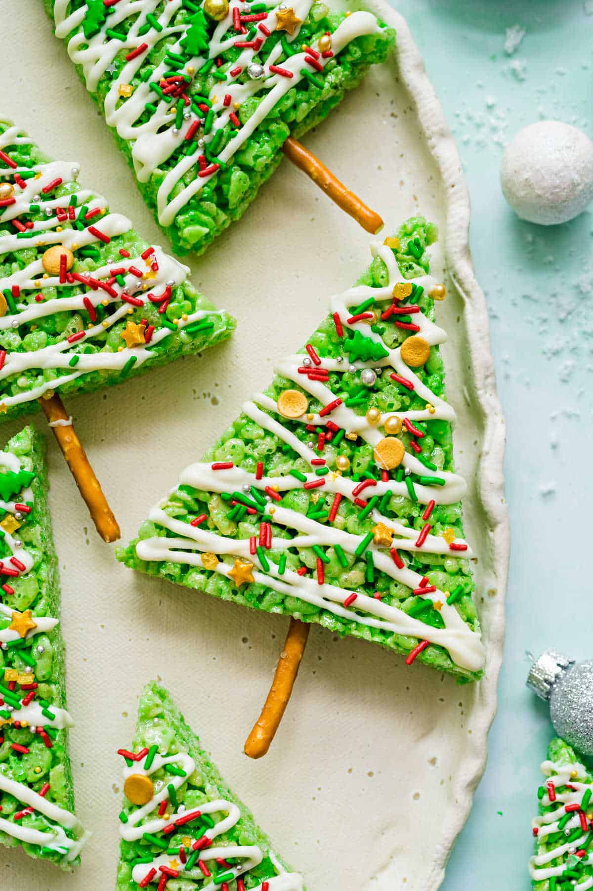 Green krispie treats shaped like Christmas trees.