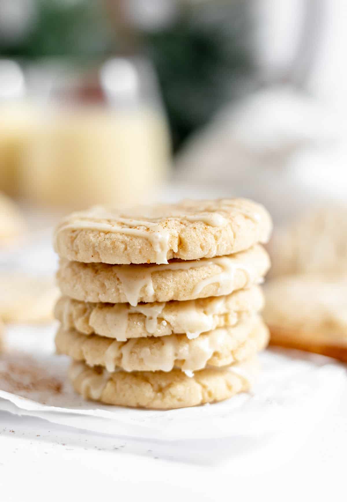 Stack of five eggnog cookies with icing.