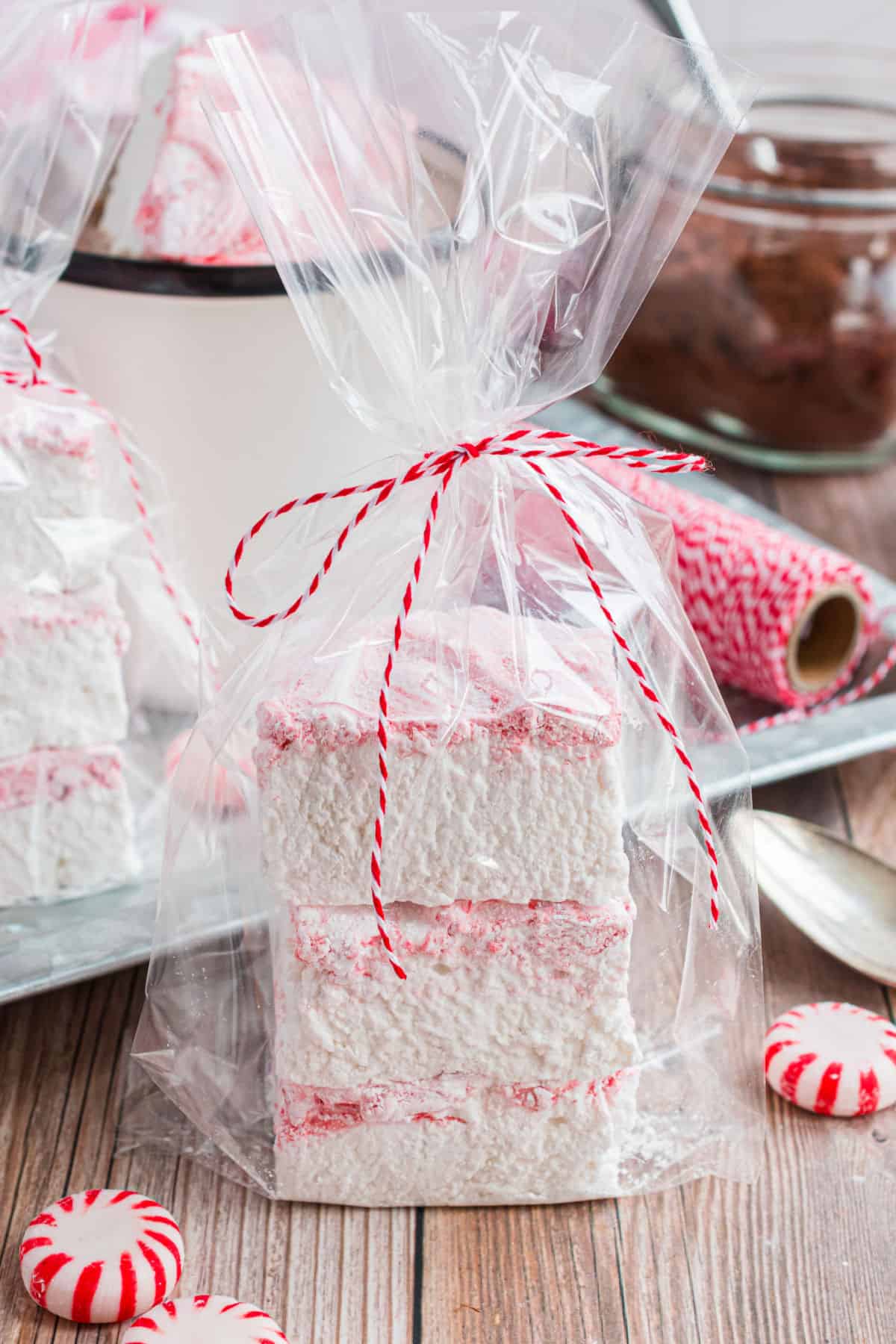 Two peppemint marshmallows wrapped in a cellophane bag for a gift.