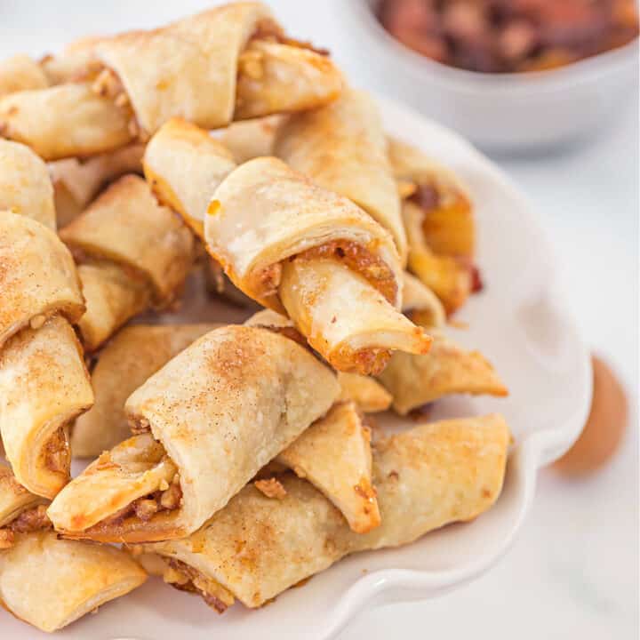 Rugelach has a rich cream cheese dough and a sweet fruity and nutty filling that gets rolled into crescent shapes and baked until flaky and delicious!