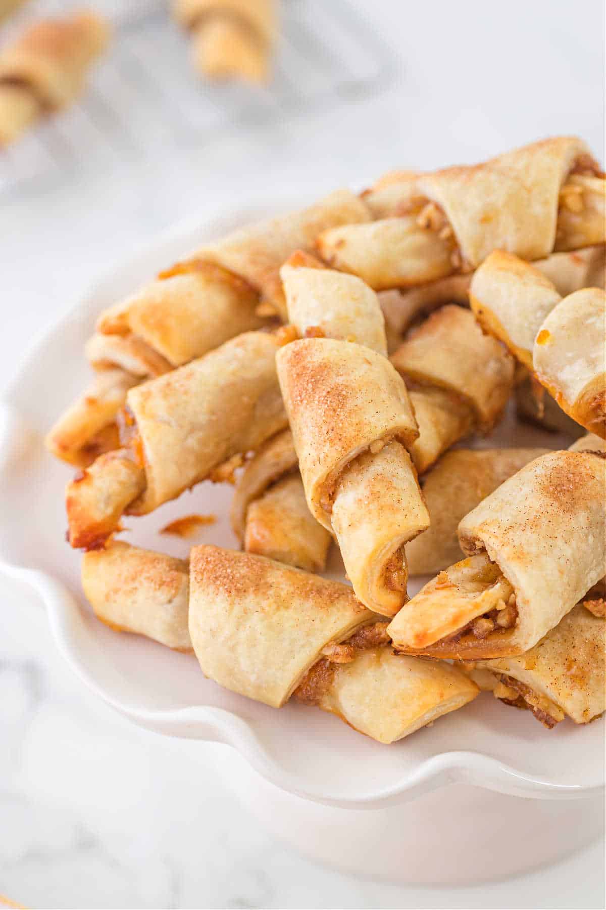 Rugelach cookies served on a fluted white platter.