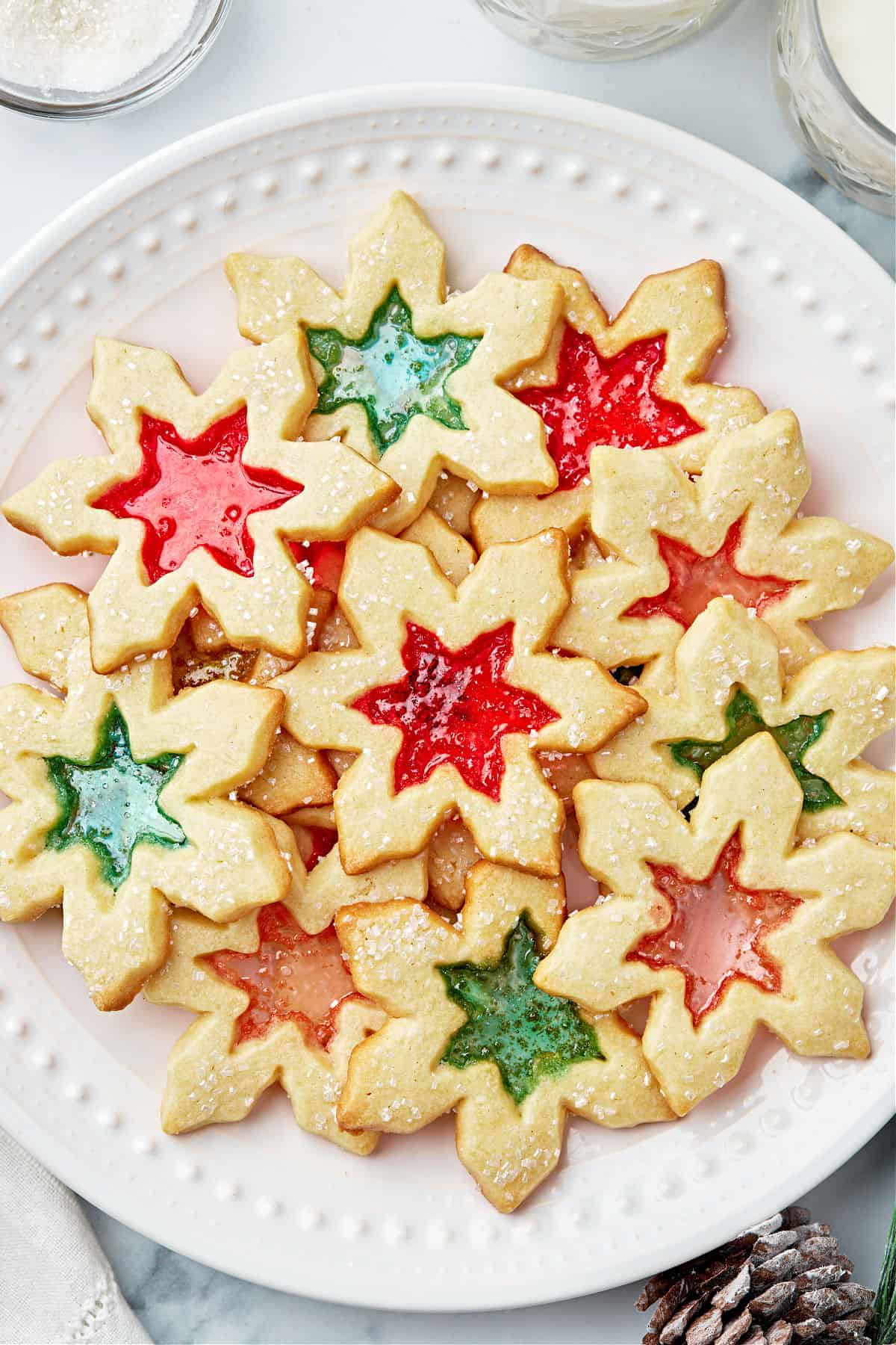 White serving plate with red and green stained glass cookies.