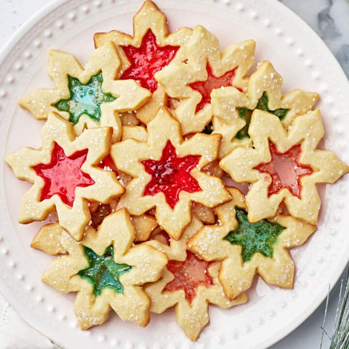 Stained Glass Cookies are buttery sugar cookies with a beautiful melted candy center that looks like stained glass windows. They are impressive but easy to make and perfect for the holidays!