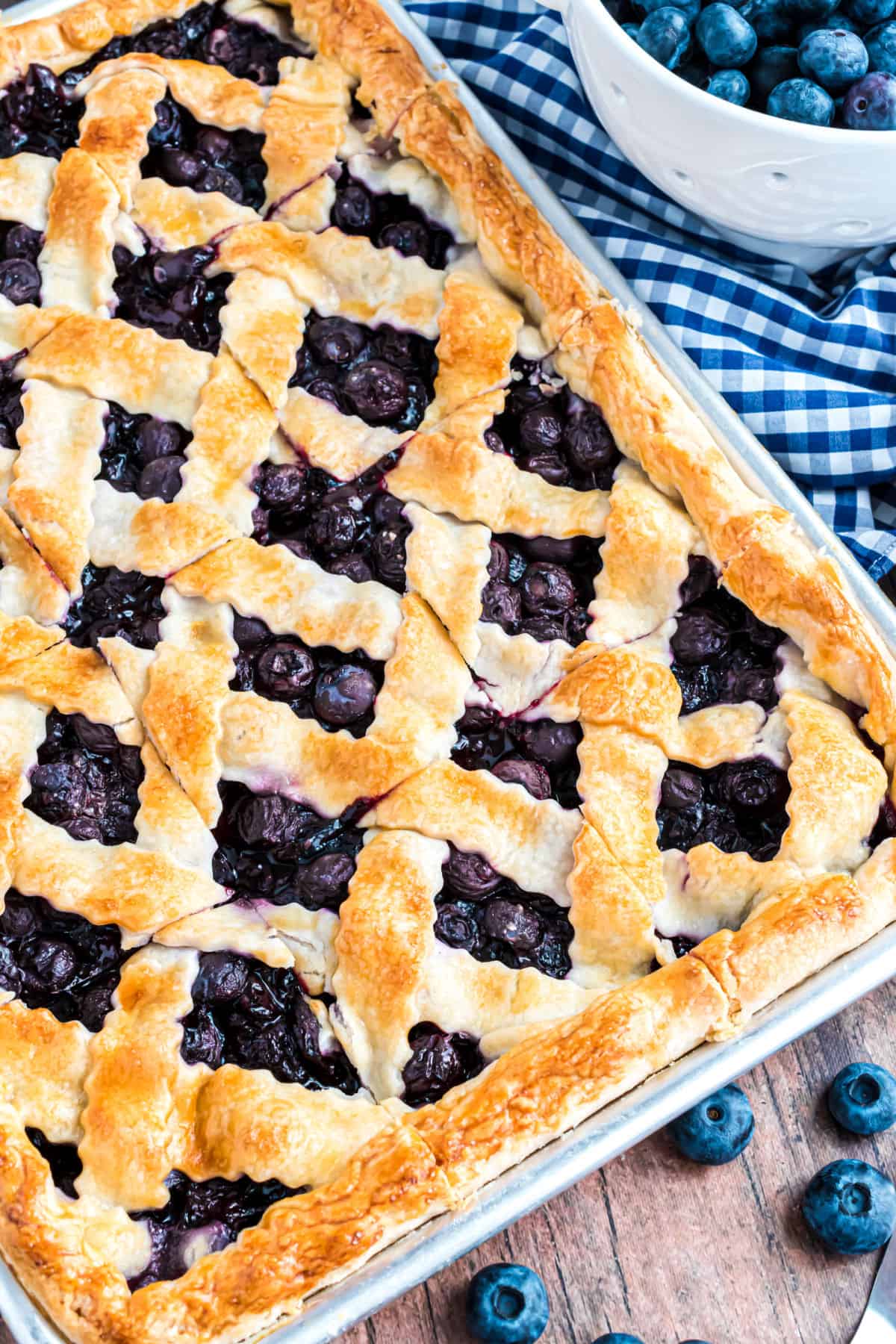 Blueberry pie baked in a sheet pan with a lattice top.