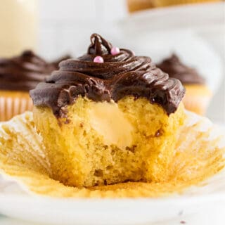 Boston Cream Cupcakes are a picture-perfect dessert with an extra dose of decadence. Moist cupcakes are filled with vanilla cream and topped with milk chocolate frosting in this easy recipe!