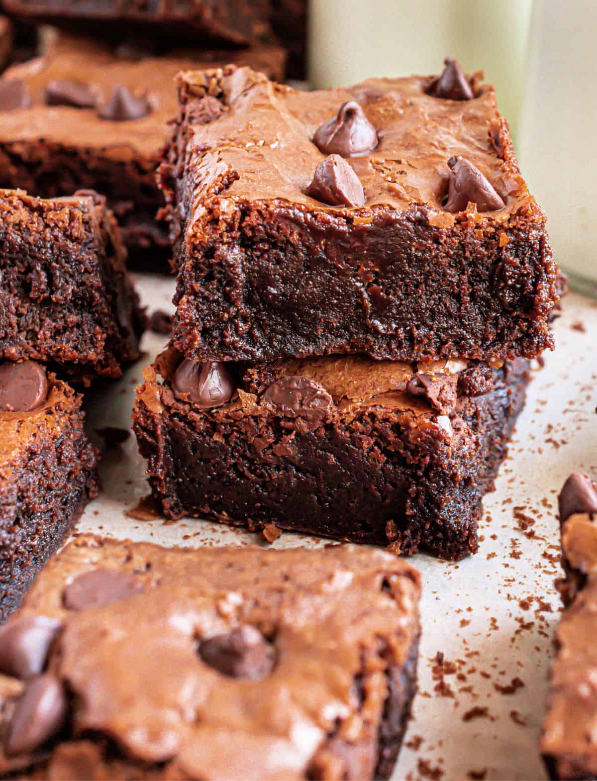 Stack of thick chocolate chip covered brownies.